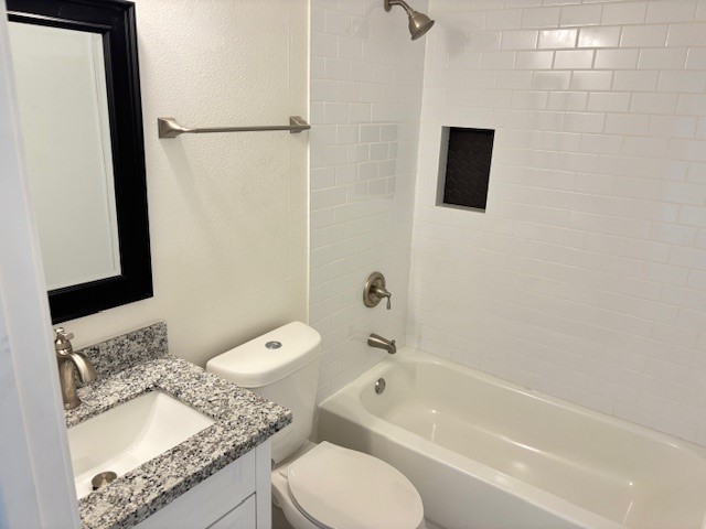 5217 Malmedy Road, Unit A Houston, TX 77033 - Photo 14 of 22 a bathroom with a granite countertop sink toilet and shower