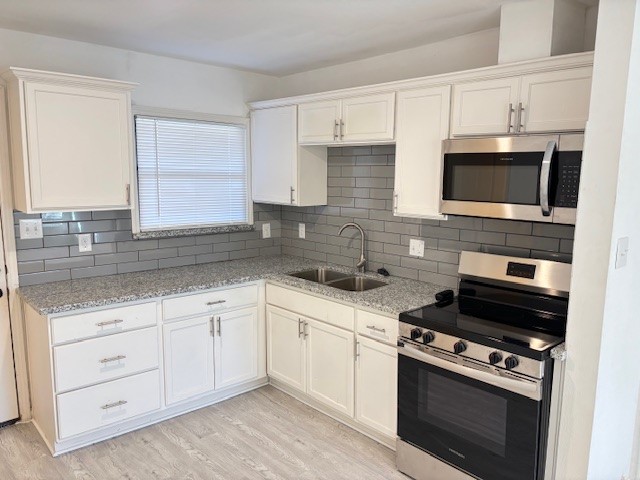 5217 Malmedy Road, Unit A Houston, TX 77033 - Photo 2 of 22 a kitchen with cabinets stainless steel appliances and a sink