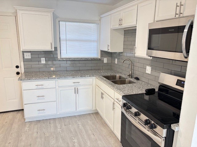 5217 Malmedy Road, Unit A Houston, TX 77033 - Photo 3 of 22 a kitchen with granite countertop a sink dishwasher stove and oven with wooden floor