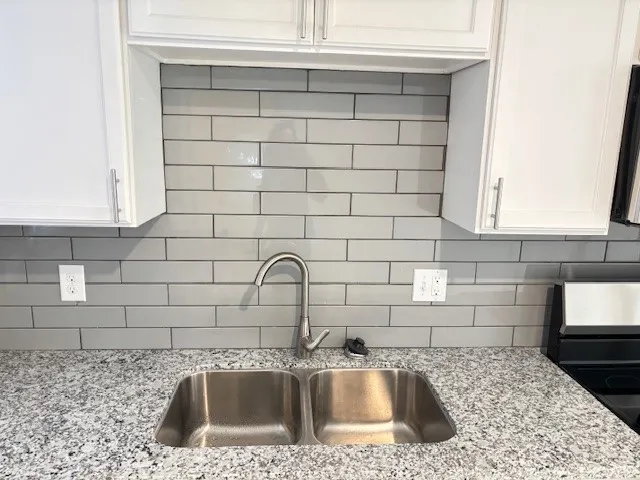 a view of a kitchen with an empty space wooden floor and a kitchen