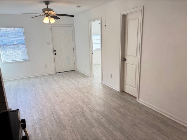 5217 Malmedy Road, Unit A Houston, TX 77033 - Photo 6 of 22 wooden floor in an empty room with a window
