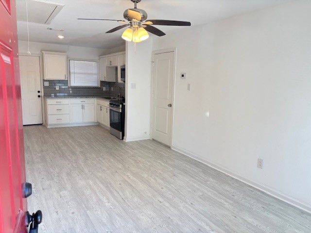 5217 Malmedy Road, Unit A Houston, TX 77033 - Photo 7 of 22 a view of a kitchen with a sink and dishwasher a refrigerator with wooden floor