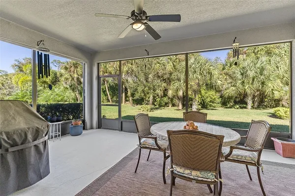 a living room with furniture and a ceiling fan