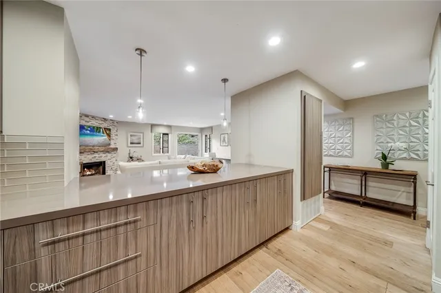 a kitchen with kitchen island a sink and a stove
