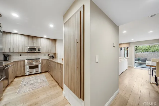 a kitchen with a refrigerator a sink and a stove top oven