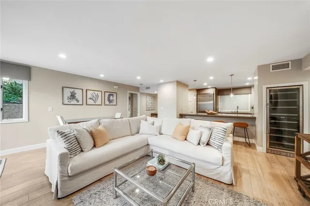 a living room with furniture and kitchen view