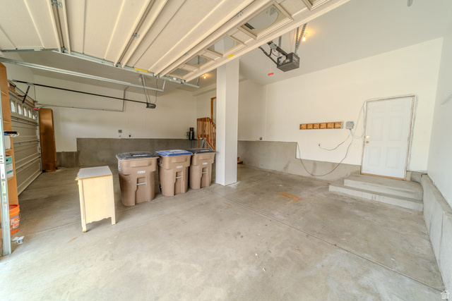 598 Hollow Creek Road Draper, UT 84020 - Photo 110 of 110 Spacious garage with light-toned walls, concrete flooring, and an overhead garage door mechanism