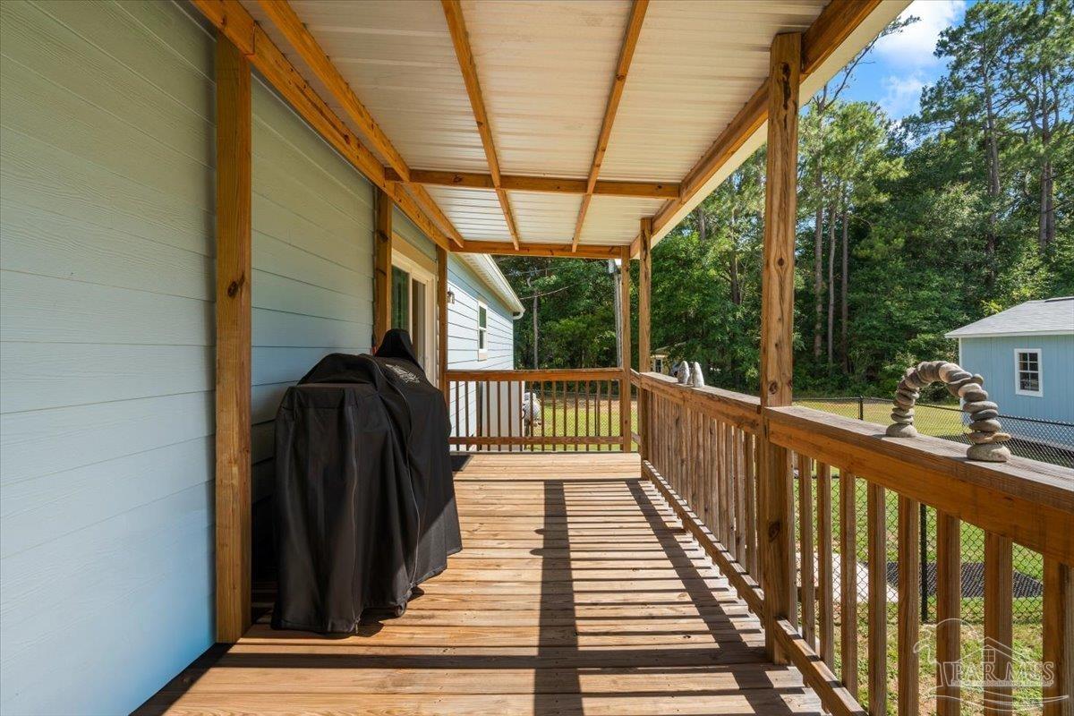 4955 Blue Ribbon Drive Milton, FL 32583 - Photo 25 of 32 a view of balcony with wooden floor and outdoor space