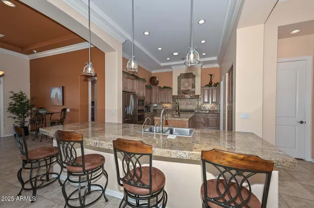 a kitchen with stainless steel appliances granite countertop a refrigerator and a sink