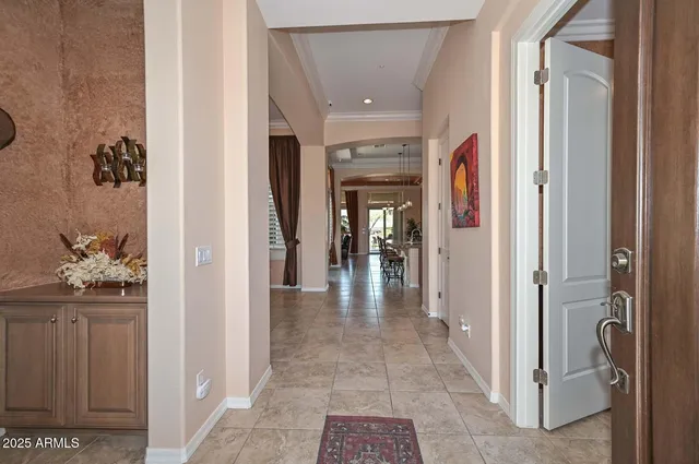 a view of a hallway with wooden floor and a bathroom