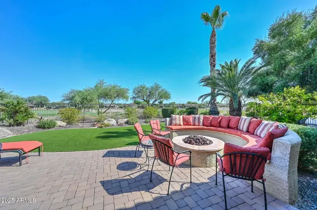 a view of tennis court with large trees
