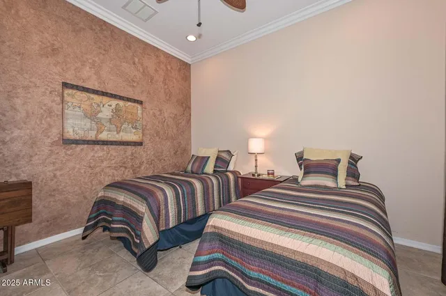 a bedroom with two beds and painting on the wall