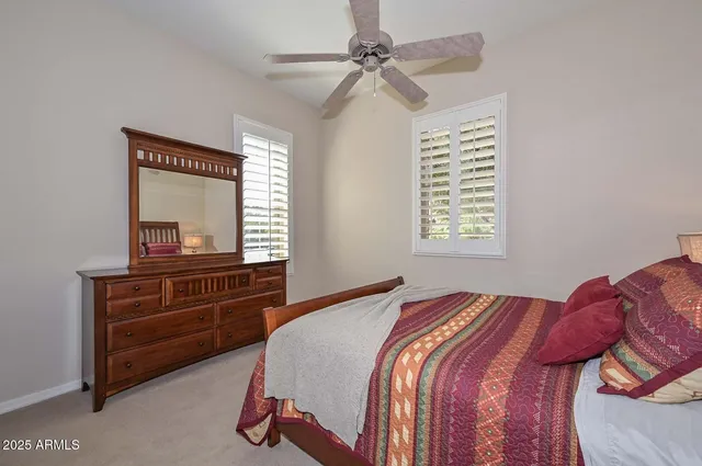 a bathroom with a sink a toilet a mirror and shower