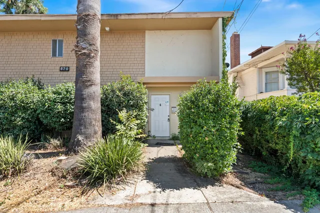 front view of a house with potted plants