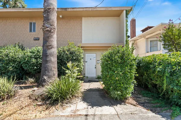 front view of a house with potted plants