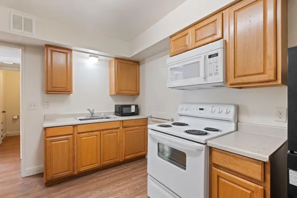 a kitchen with stainless steel appliances granite countertop a stove and a sink