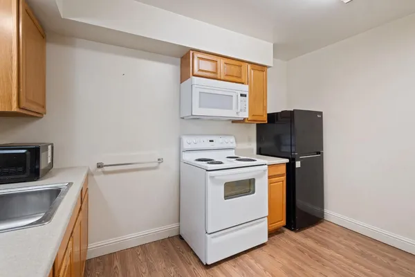 a kitchen with a stove microwave and sink