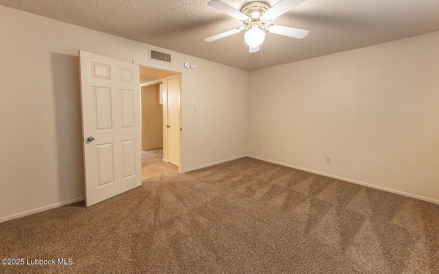 5750 38th Street Lubbock, TX 79407 - Photo 14 of 24 an empty room with a empty space and a ceiling fan