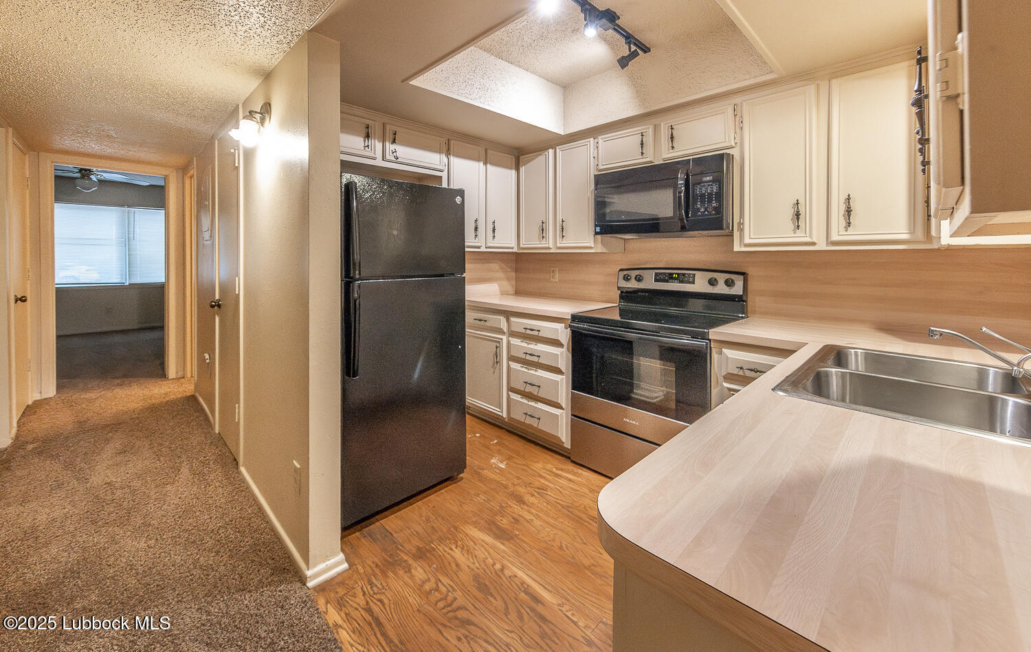 5750 38th Street Lubbock, TX 79407 - Photo 3 of 24 a kitchen with stainless steel appliances granite countertop a refrigerator a stove and a sink