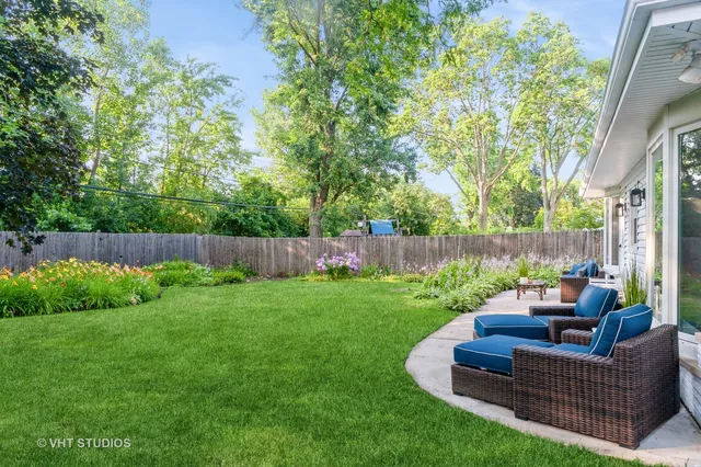 a view of a garden with furniture