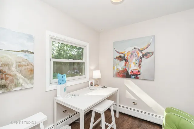 a view of a dining room with furniture and a window