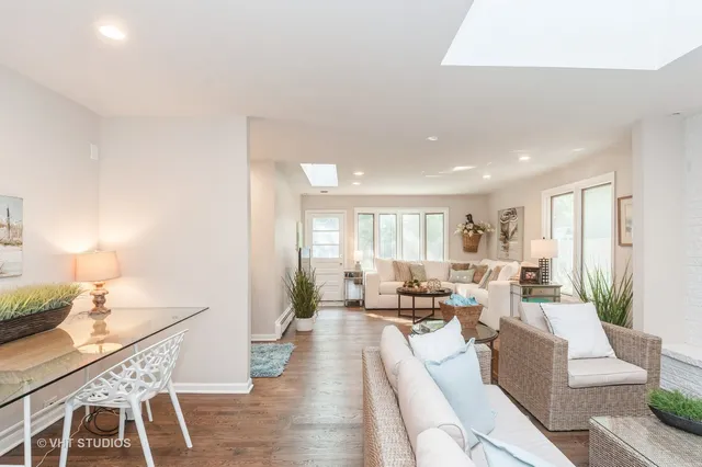 a living room with furniture wooden floor and a lamp