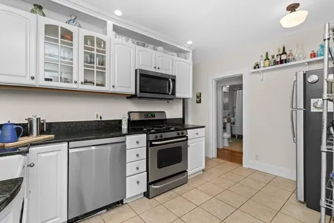 a kitchen with stainless steel appliances granite countertop a stove and a refrigerator
