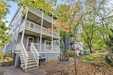 a view of a house with backyard and sitting area