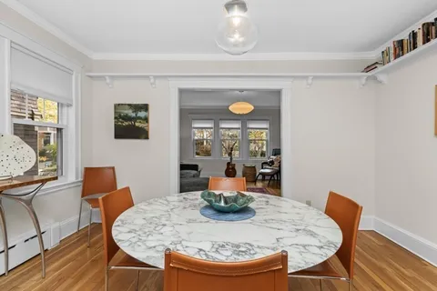 a dining room with furniture and wooden floor