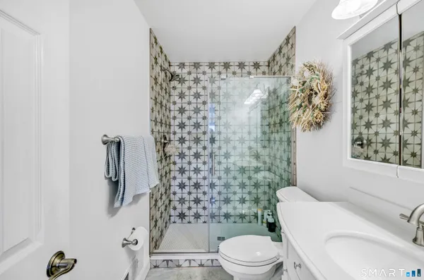 a bathroom with a toilet and shower