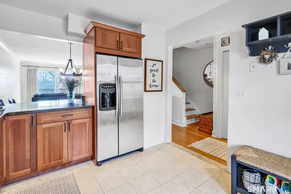 a kitchen with stainless steel appliances granite countertop a refrigerator and a sink