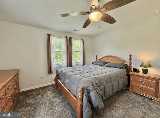 a view of room with walk in closet and wooden floor