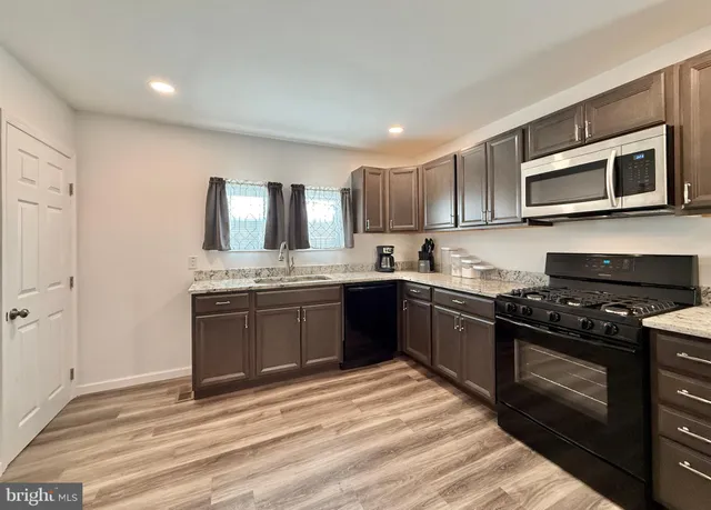 a kitchen with a sink stove and microwave