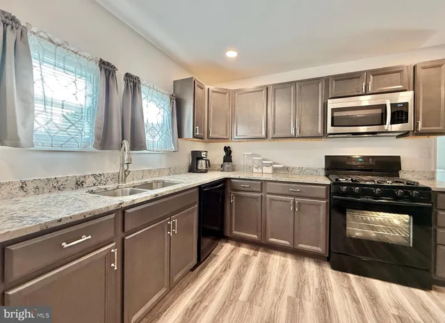 a view of a dining room with furniture and a chandelier