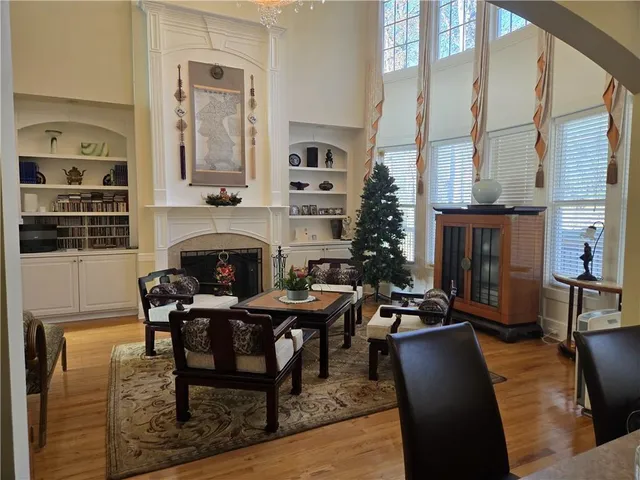a living room with furniture a fireplace and a table