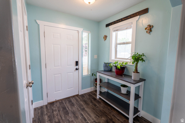 1443 West 250 North Springville, UT 84663 - Photo 11 of 23 Entryway featuring a paneled door with smart lock, vertical window with blinds, and wood-finish flooring