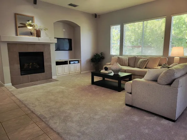 a living room with furniture and a fireplace