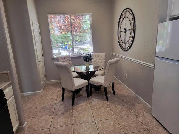 a view of a dining room with furniture and a window