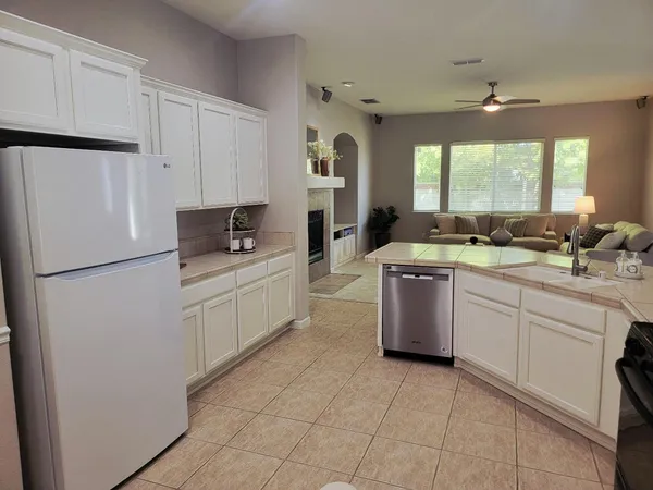a kitchen with a sink stove and refrigerator