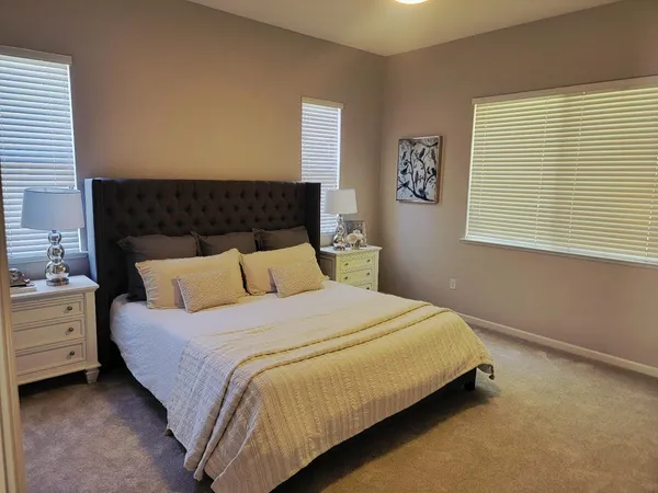 a bed sitting in a bedroom next to a window