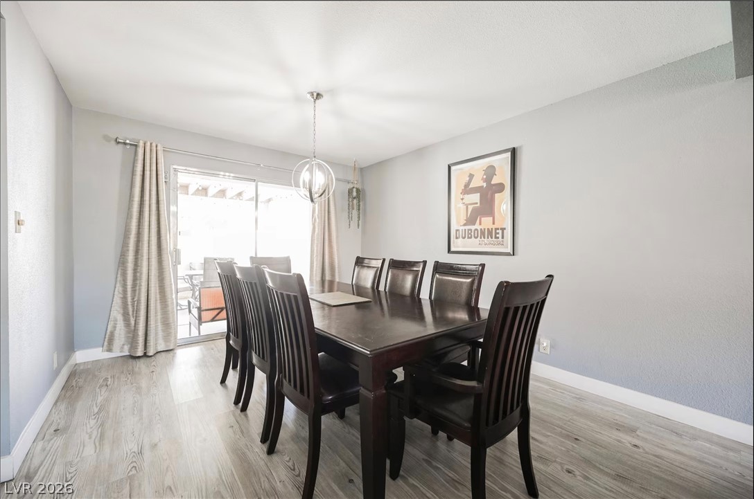 1803 Nuevo Road Henderson, NV 89014 - Photo 17 of 71 Dining space featuring light wood-type flooring and a chandelier