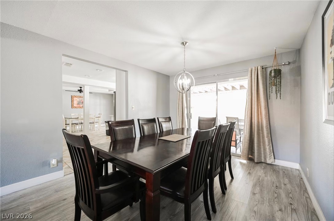 1803 Nuevo Road Henderson, NV 89014 - Photo 18 of 71 Dining room with light wood-style flooring and suspended lighting
