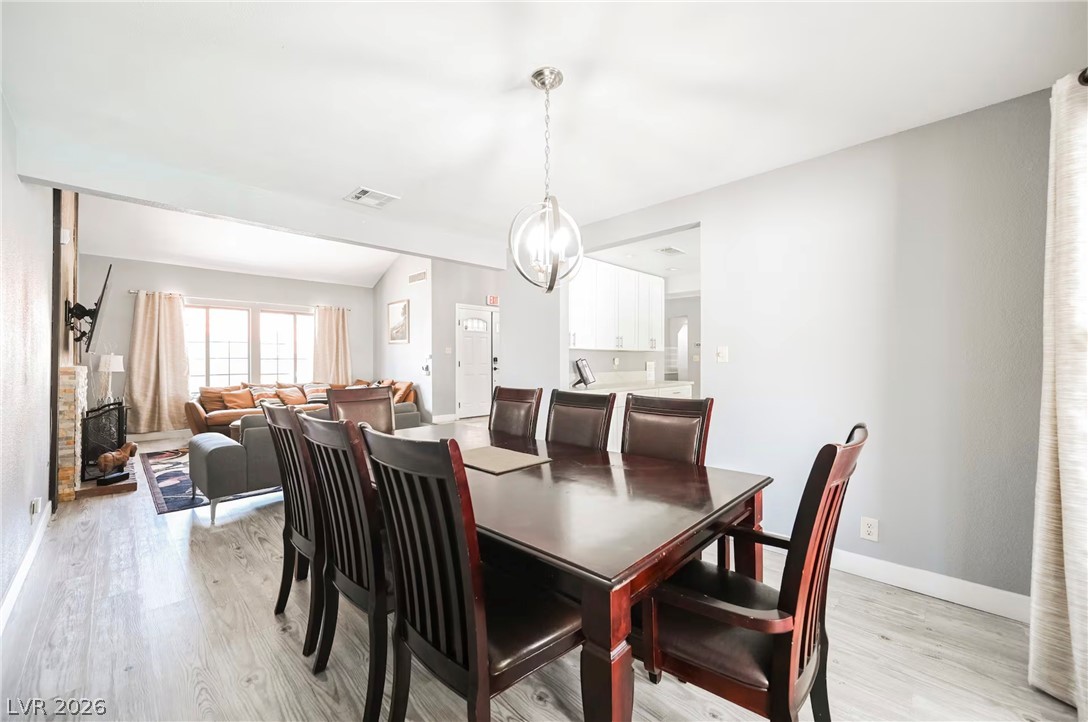 1803 Nuevo Road Henderson, NV 89014 - Photo 19 of 71 Dining area featuring light wood-style flooring and hanging lights