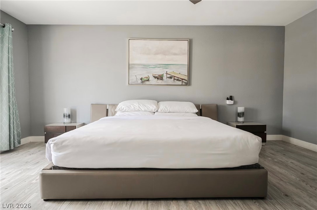 1803 Nuevo Road Henderson, NV 89014 - Photo 22 of 71 Bedroom featuring baseboards and light wood finished floors