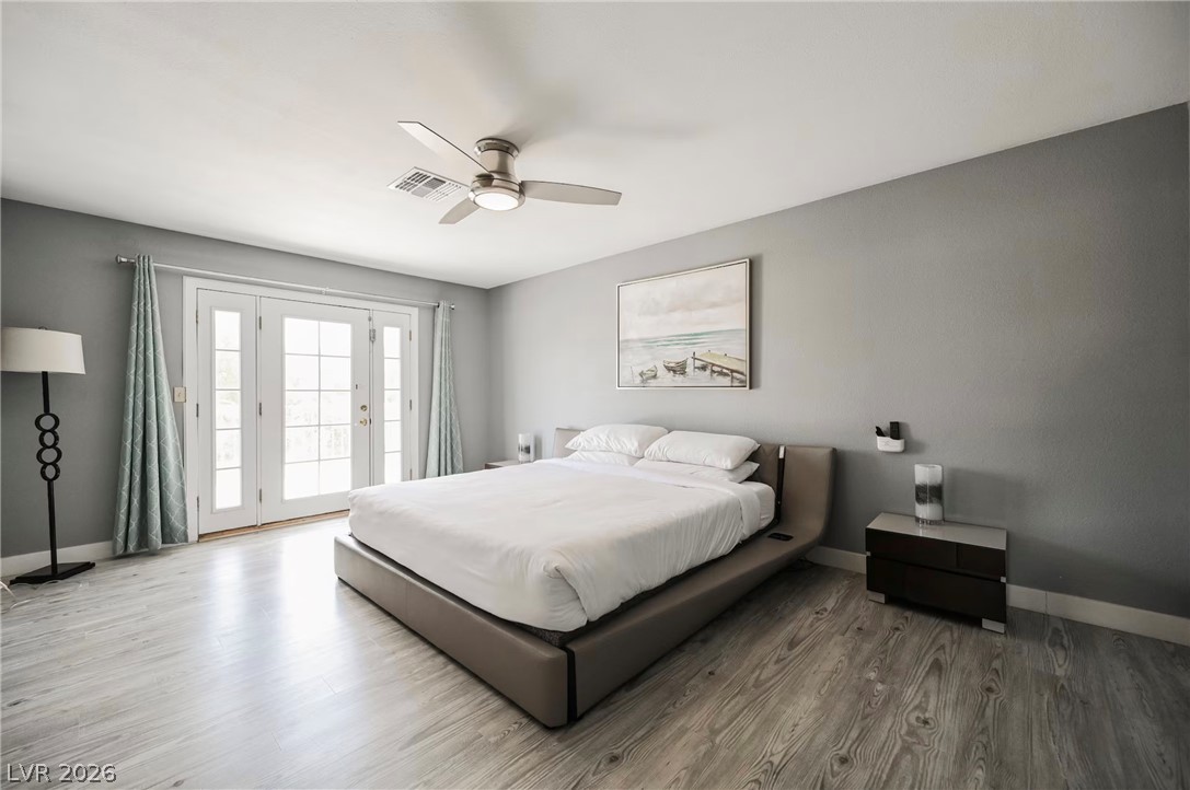 1803 Nuevo Road Henderson, NV 89014 - Photo 23 of 71 Bedroom featuring wood finished floors, access to outside, and a ceiling fan
