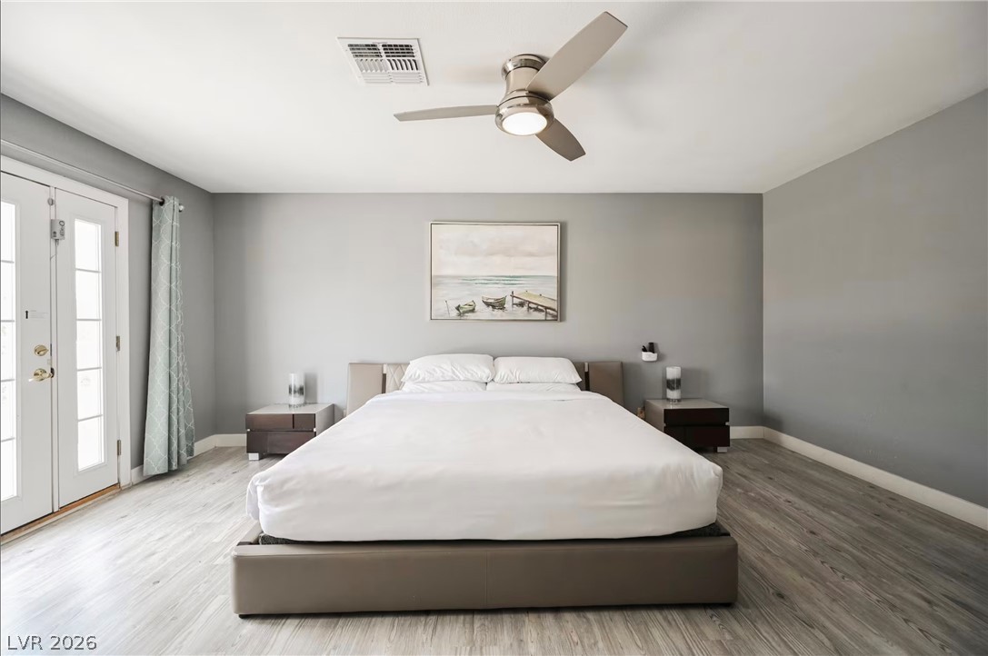 1803 Nuevo Road Henderson, NV 89014 - Photo 24 of 71 Bedroom with light wood finished floors, access to exterior, and a ceiling fan