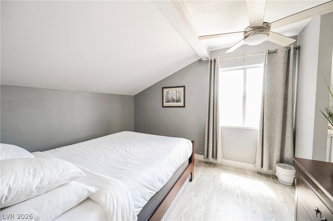1803 Nuevo Road Henderson, NV 89014 - Photo 29 of 71 Bedroom featuring light wood-style floors, vaulted ceiling, and ceiling fan