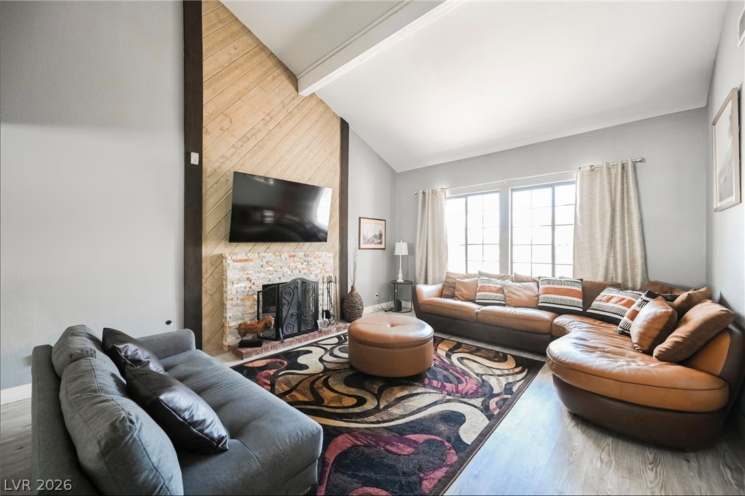 1803 Nuevo Road Henderson, NV 89014 - Photo 3 of 71 Living area with a fireplace, lofted ceiling, and wood finished floors