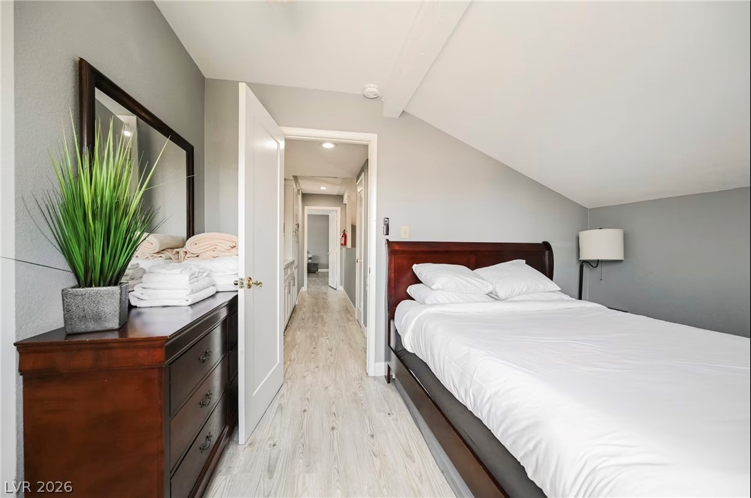 1803 Nuevo Road Henderson, NV 89014 - Photo 31 of 71 Bedroom with light wood-style flooring and vaulted ceiling