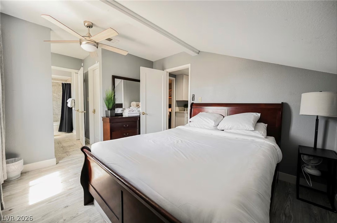 1803 Nuevo Road Henderson, NV 89014 - Photo 32 of 71 Bedroom featuring light wood-type flooring, ceiling fan, and beam ceiling